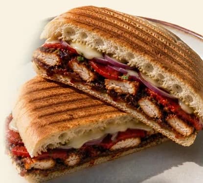 Hanna’s toasted BBQ chicken panini, cut to show the chicken, cheese, and peppers