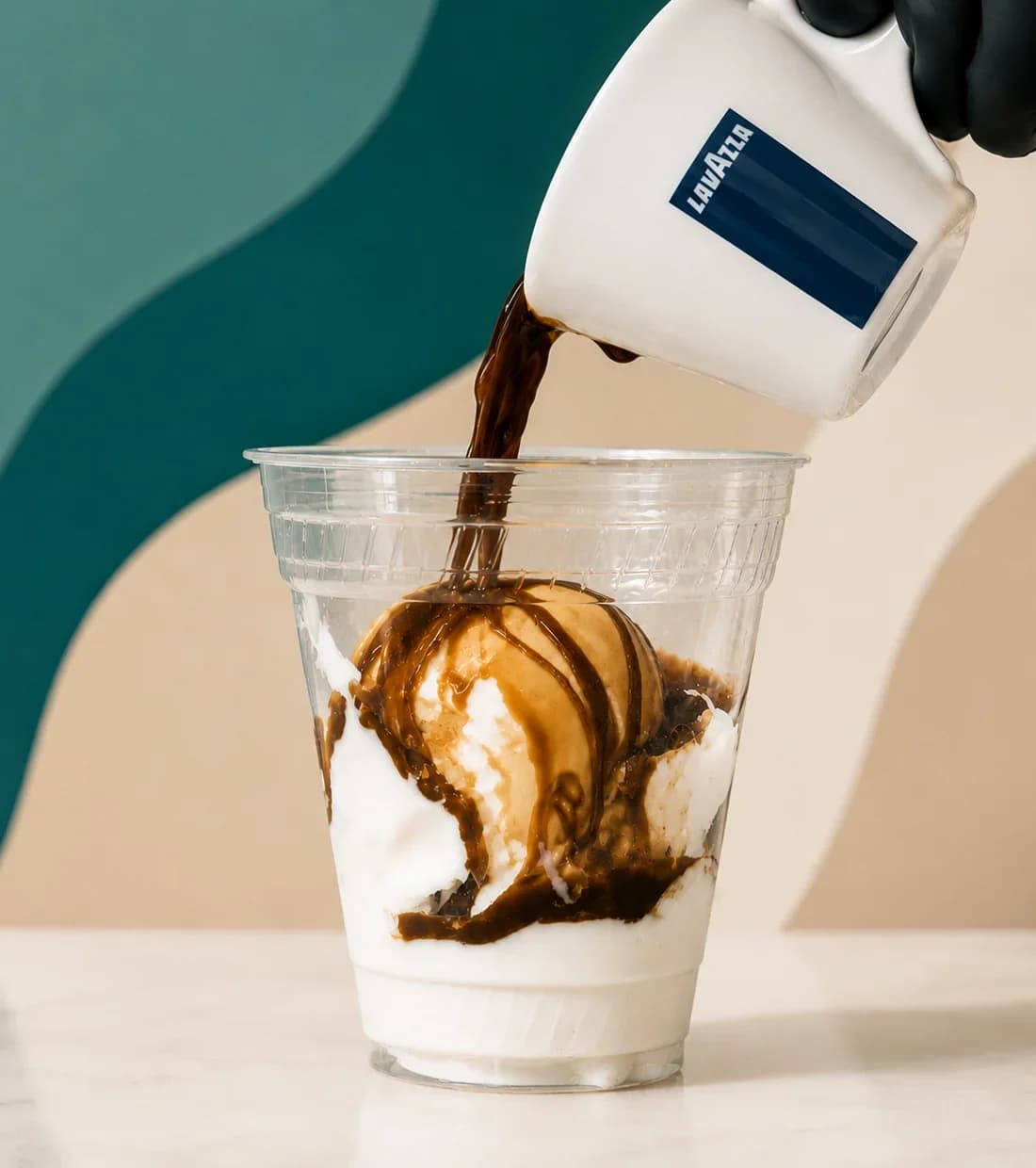 Espresso being poured over gelato for an affogato